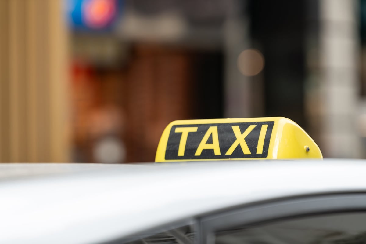 Detalle de la señal luminosa de un taxi con fondo urbano desenfocado
